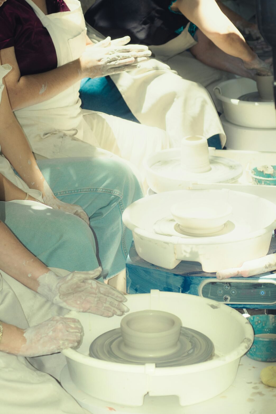 A group of people learning pottery.