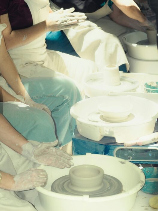 A group of people learning pottery.