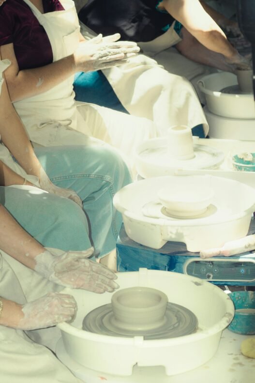 A group of people learning pottery.