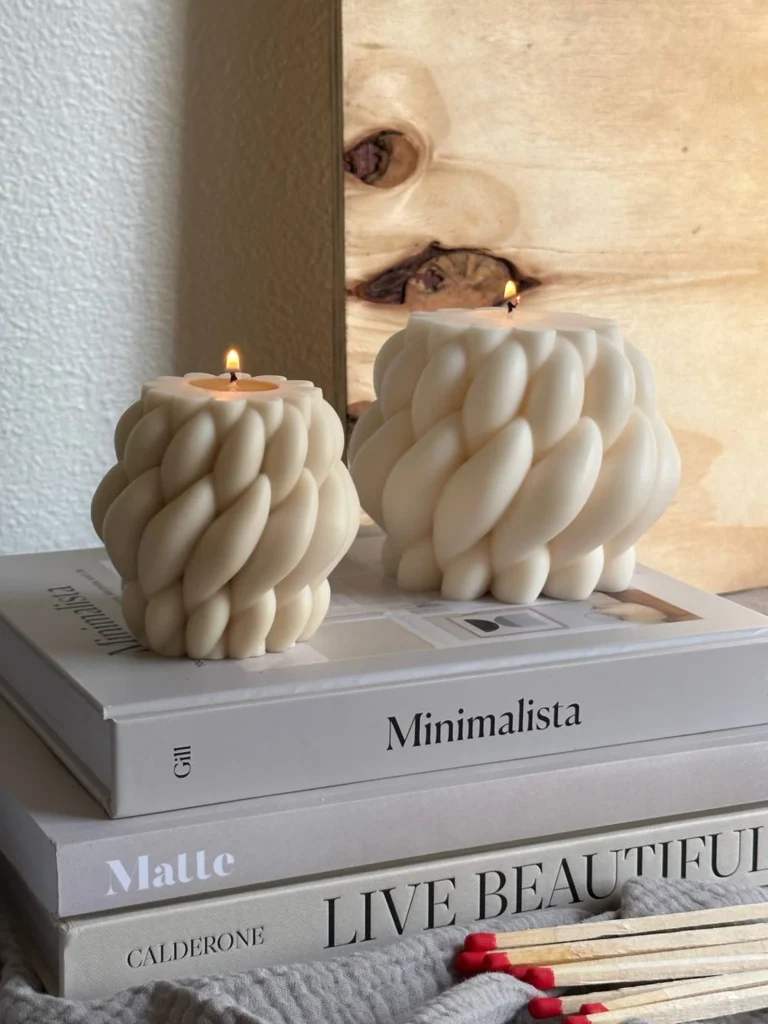 Handmade candles on a stack of books at the golden hour.