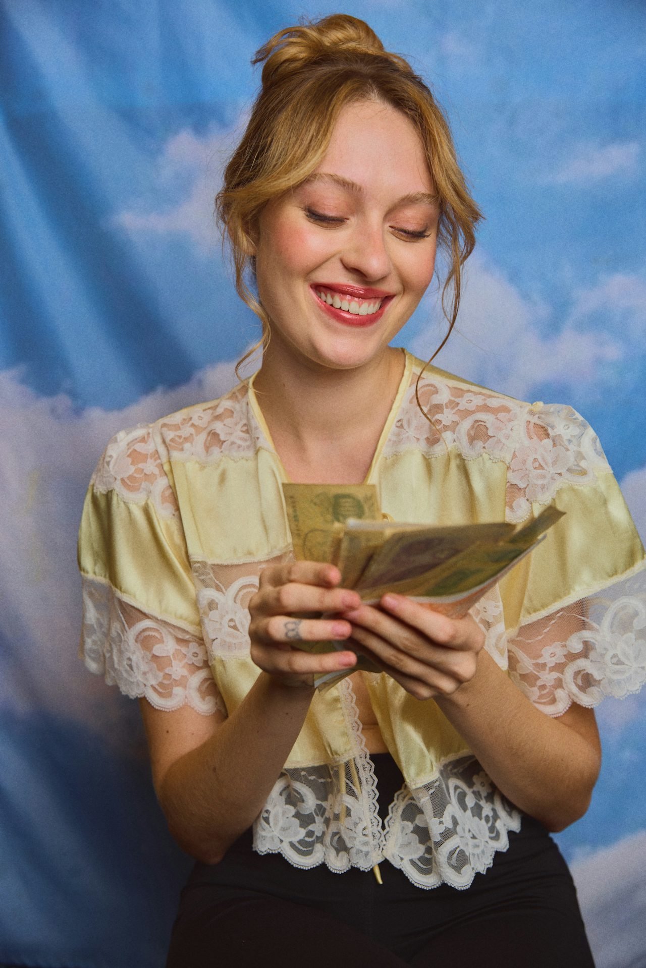 A young woman thumbing through some cash