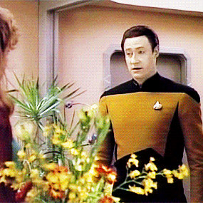 Data opening his arms to Ensign McKnight.
