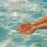 A woman cups her hands underwater