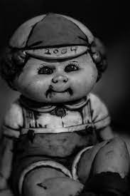 A dusty Cabbage Patch Kid staring blankly into the abyss, possibly communing with spirits.