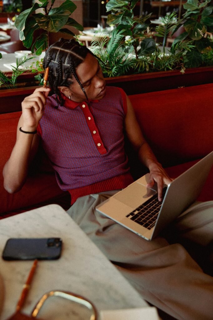 A POC sitting in a restaurant with their laptop