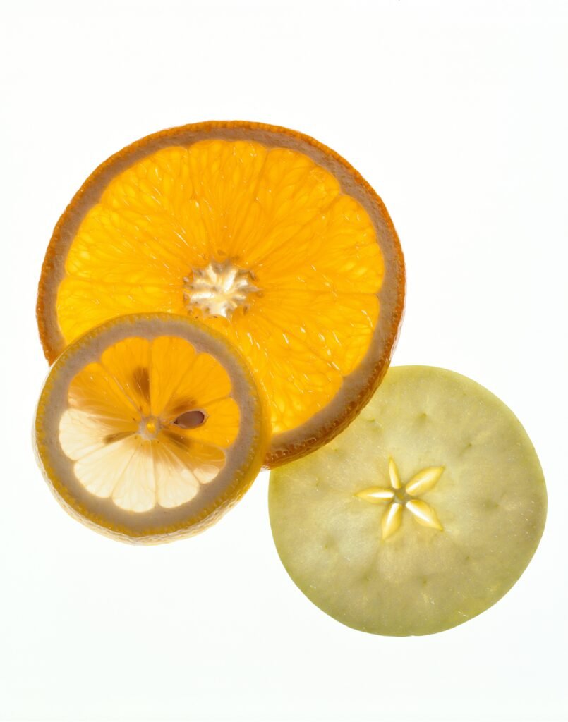 Three very thinly sliced citrus fruits
