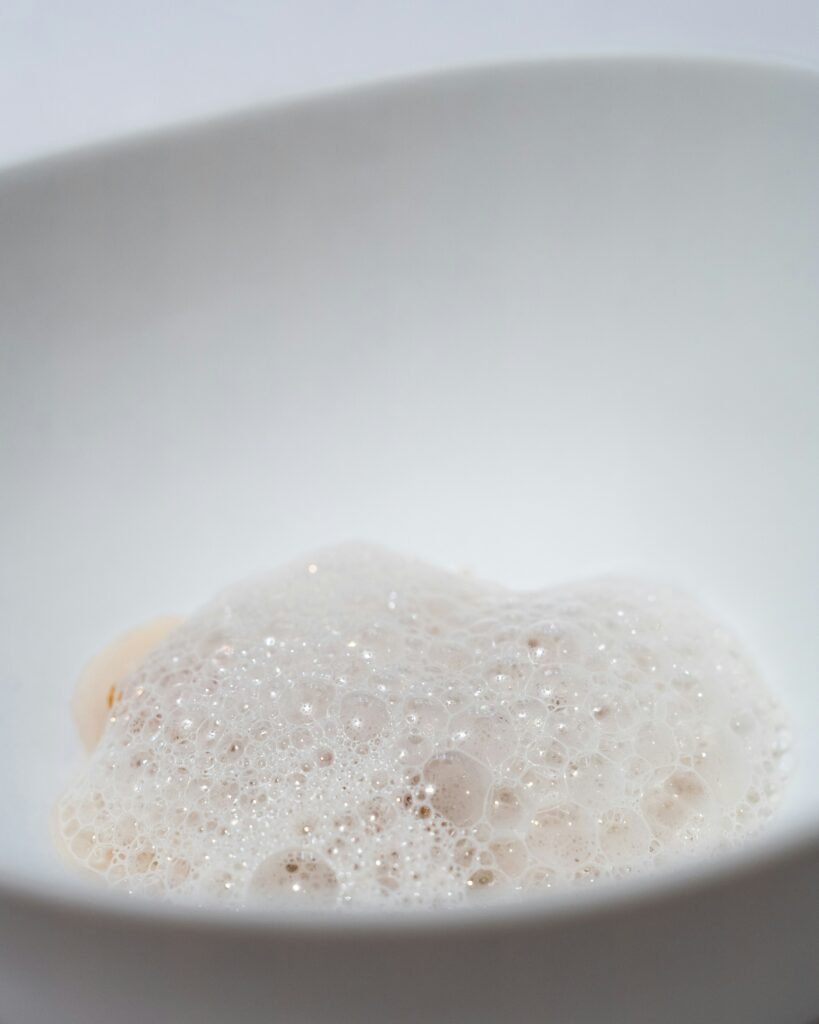 A shallow bowl of foaming liquid.