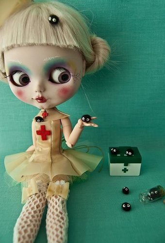 A Blythe doll dressed as a zombie nurse.