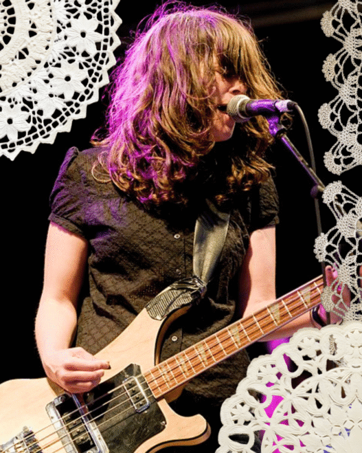 An image of Julie Doiron performing with Eric's Trip with doilies collaged around the edges