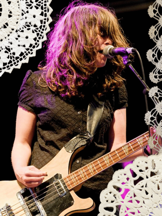 An image of Julie Doiron performing with Eric's Trip with doilies collaged around the edges