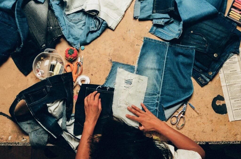 Denim spread out across a seamstress's work table.