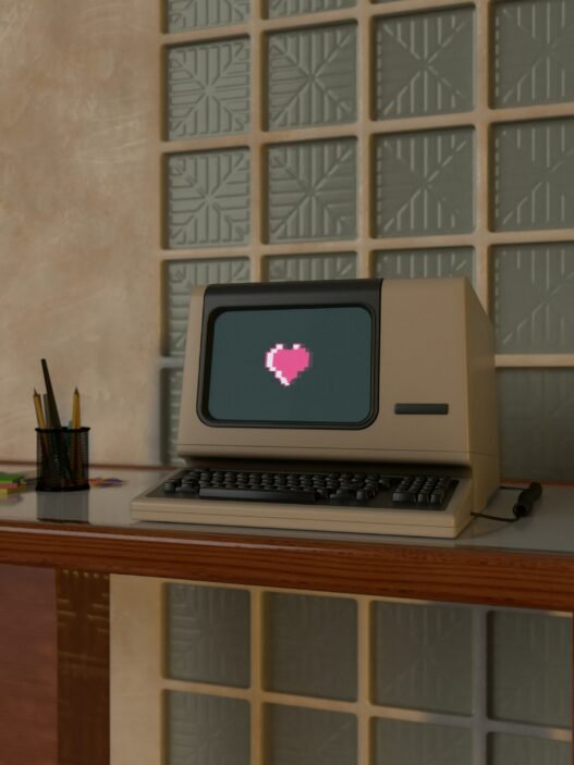 A vintage computer with a bitmoji heart on the screen.
