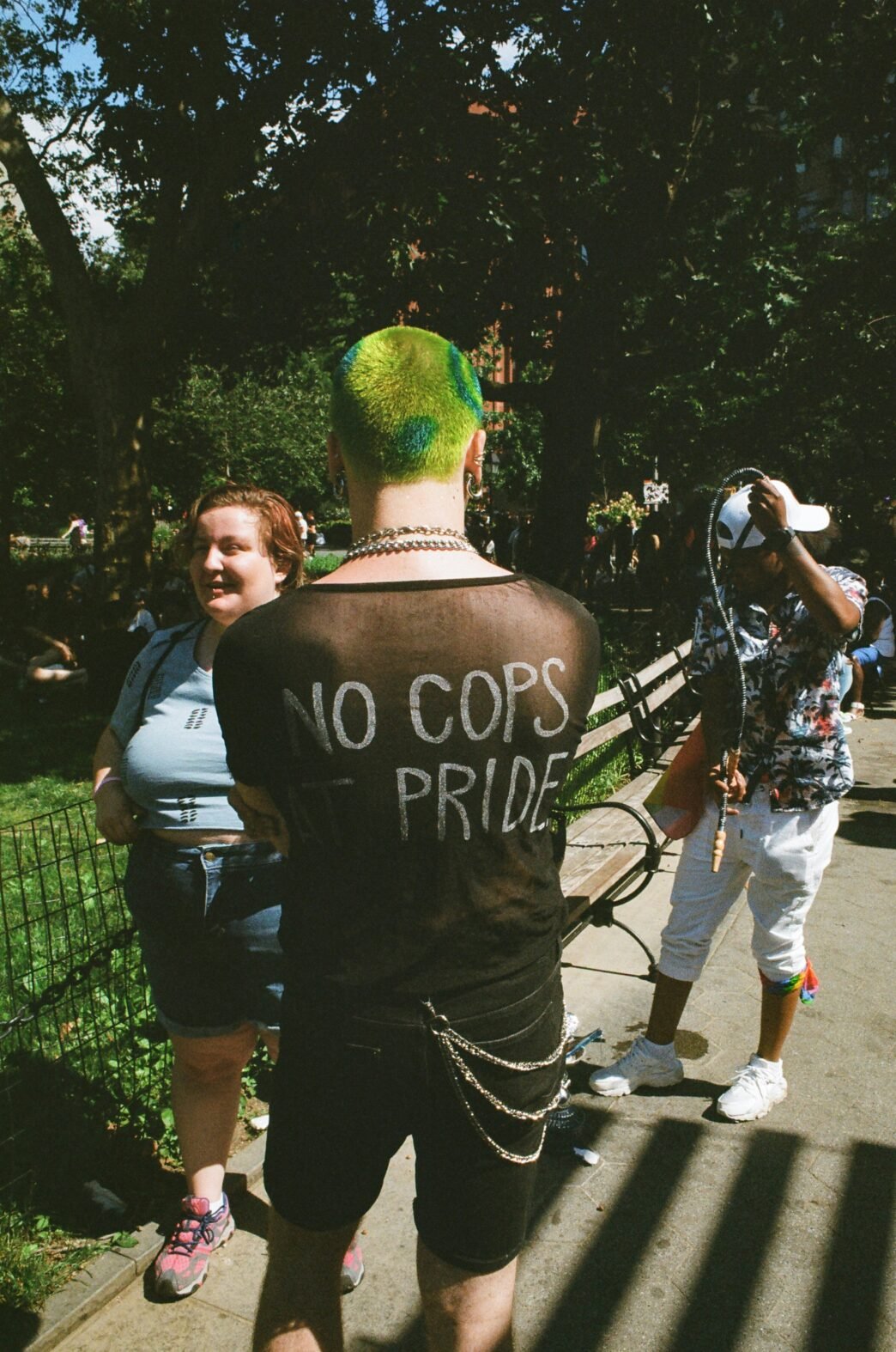 A punk with the writing 'No Cops at Pride' on the back of their shirt.