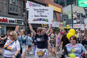 Protesters at a Pride parade supporting queer healthcare workers and patients.