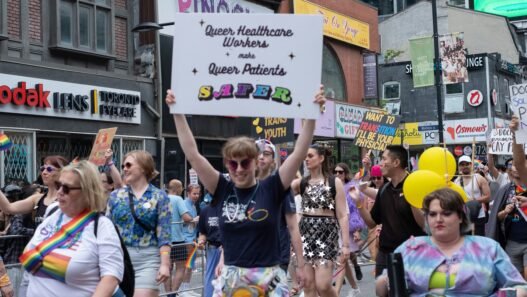 Protesters at a Pride parade supporting queer healthcare workers and patients.